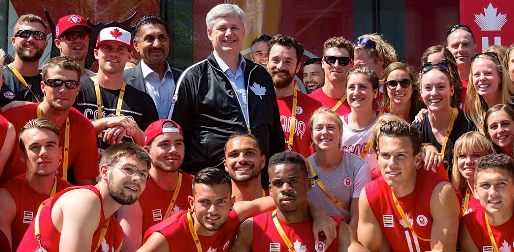 Prime Minister Stephen Harper, shown getting cozy with Canadian athletes this month, believes Bill C-24 strengthens citizenship. (Stephen Harper)